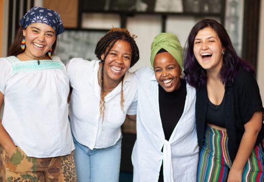 group of four women smiling